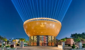 Prédio em formato de peteca iluminado à noite na Índia, centro de badminton The Shuttle projetado pelo escritório Archohm.